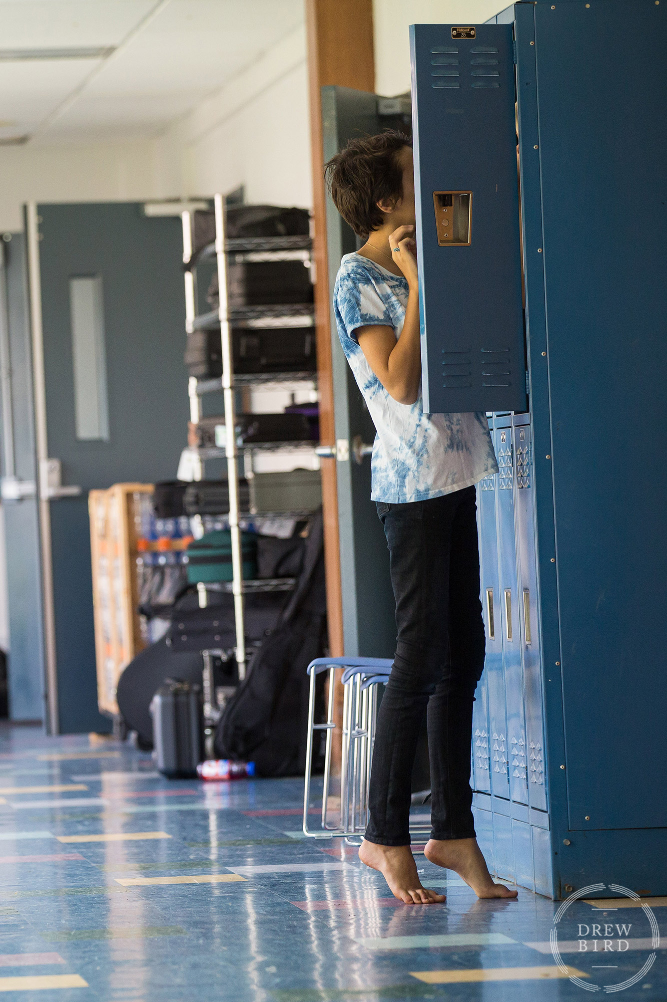 A student in bare feet on tip toes at their locker at Poughkeepsie Day School in Hudson Valley, New York. San Francisco education marketing photographer Drew Bird. San Jose school branding photographer.